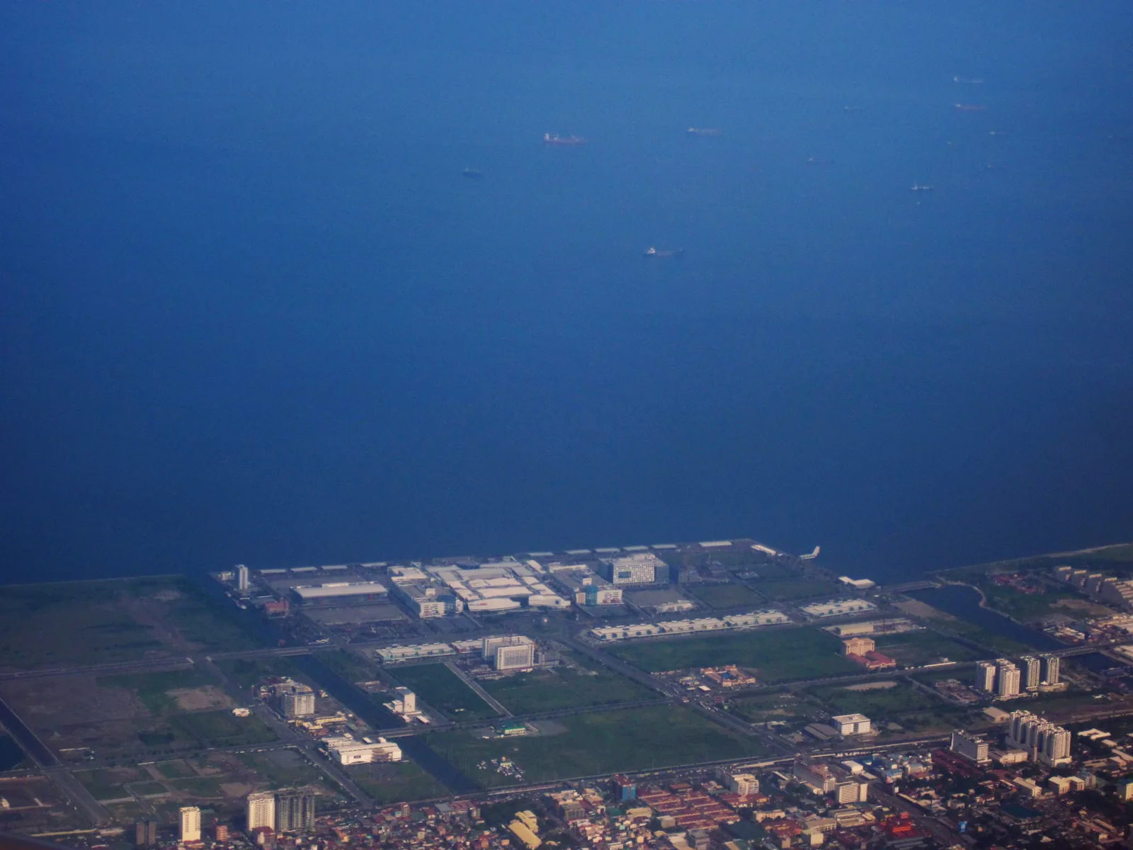 Aerial view of the SM Mall of Asia complex in Pasay, with Manila Bay and the reclaimed land around it.